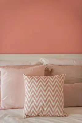 a bed with white pillows and a pink wall at \u6d77\u666f\u623f Seaview 218 Macalister (Georgetown) \u4e54\u6cbb\u5e02\u4e2d\u5fc3 9pax in George Town