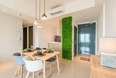 a dining room with a table and chairs and a green wall at \u6d77\u666f\u623f Seaview 218 Macalister (Georgetown) \u4e54\u6cbb\u5e02\u4e2d\u5fc3 9pax in George Town