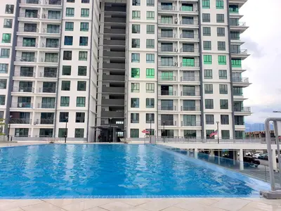 a large swimming pool in front of two tall buildings at Ipoh Meru Casa Kayangan by BeeStay in Ipoh
