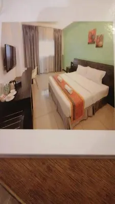 a hotel room with a bed and a desk at Ipoh Downtown Hotel in Ipoh