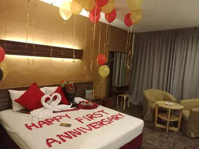 a room with a bed with a happy new year sign on it at De Botani Hotel in Ipoh