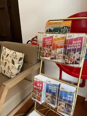 a rack of books sitting on top of a couch at Mclane Boutique Hotel in George Town