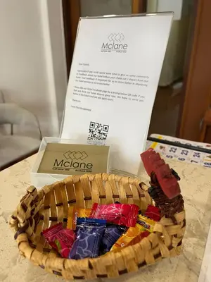 a basket of chocolates sitting next to a box at Mclane Boutique Hotel in George Town