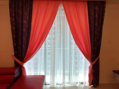 a window with red curtains and a red couch at KJ Homestay Casa Kayangan in Ipoh