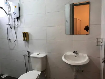 a bathroom with a toilet and a sink at KJ Homestay Casa Kayangan in Ipoh