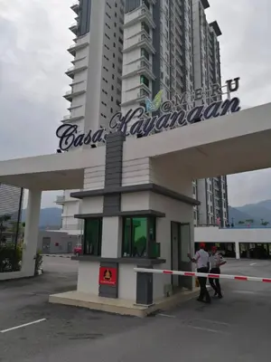 two people standing in front of a building at KJ Homestay Casa Kayangan in Ipoh