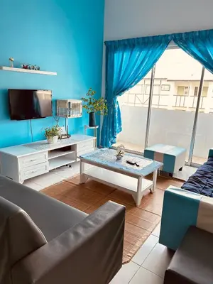 a living room with a couch and a table at The Sky - The Cave Guest House in Tanah Rata