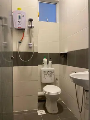 a bathroom with a toilet and a sink at The Sky - The Cave Guest House in Tanah Rata
