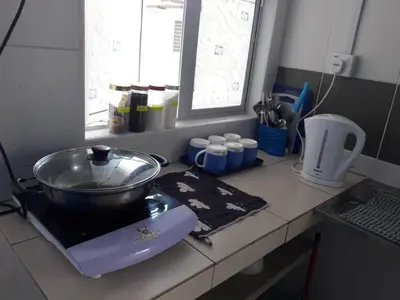 a kitchen counter with a bowl on top of a mixer at The Cave - Adults Only in Tanah Rata
