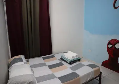 a bedroom with a bed with a spider man pillow at Marvel Cinematics Homes@ Station 18 , Ipoh in Ipoh
