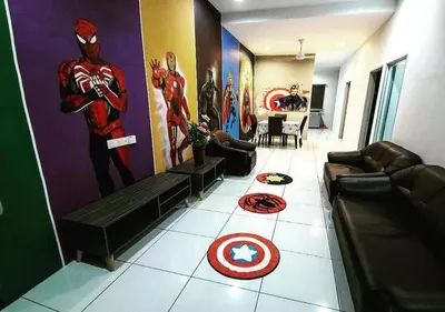 a living room with a spider man painting on the wall at Marvel Cinematics Homes@ Station 18 , Ipoh in Ipoh
