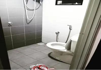 a bathroom with a toilet and a shower stall at Marvel Cinematics Homes@ Station 18 , Ipoh in Ipoh