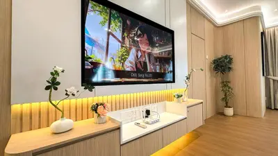 a living room with a tv on the wall at My Cool Home x The Quintet @ Cameron Highlands in Tanah Rata