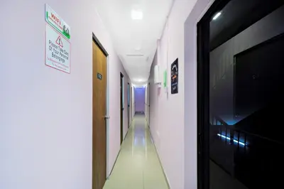 a long hallway with a television and a hallway with at Hotel O City Hostel Ipoh in Ipoh