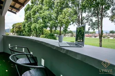 a laptop computer sitting on a table on a patio at L&P Boutique Residence by Verve (14 Pax) EECH40 in Ipoh
