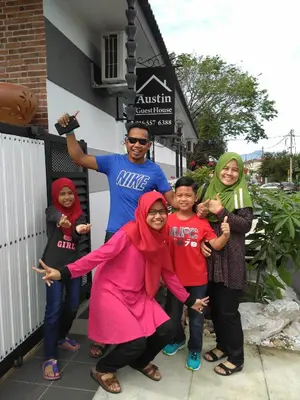 a group of people standing in front of a building at Austin Homestay in Ipoh