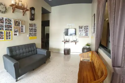 a living room with a couch and a tv at Austin Homestay in Ipoh