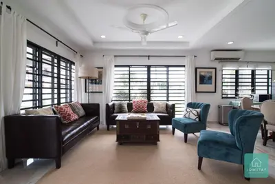 a living room with a couch and a table and chairs at Jomstay Mayhaven Villa (Ipoh) in Ipoh