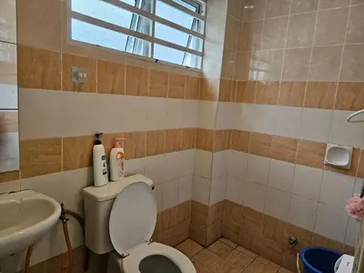 a bathroom with a toilet and a sink at Jeffrey Homestay Ipoh R at Lost World of Tambun in Tambun