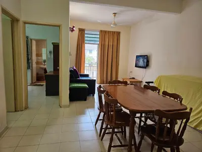 a living room with a table and a bedroom at Jeffrey Homestay Ipoh R at Lost World of Tambun in Tambun