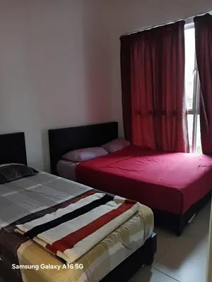 two beds sitting next to each other in a room at Galina Somersquare Goldenhills Aprt Pasar Malam Cameron Highlands in Brinchang