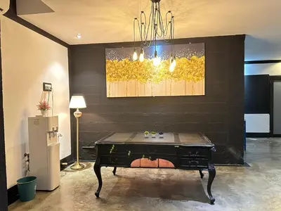 a table in a room with a painting on the wall at CJ HOUSE station 18 Ipoh in Ipoh