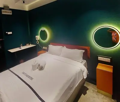 a bedroom with a large white bed and a sink at CJ HOUSE station 18 Ipoh in Ipoh