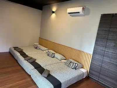a room with four beds with pillows on them at Tatami D'Tepi Laut - PANGKOR ISLAND in Pangkor
