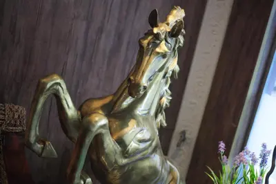 a bronze horse statue in front of a door at HOTEL PREMIUM in Ipoh
