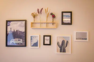 a wall with pictures and a shelf on it at Cameron Highlands Modern7-Tea Plantation View-Premium Hotel Bed in Kampung Kuala Terla
