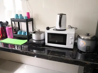 a microwave sitting on a counter in a kitchen at My Homestay N18 (14 pax) @ Golden Hills Night Market in Brinchang