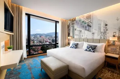 a bedroom with a large bed and a large window at OZO George Town Penang in George Town