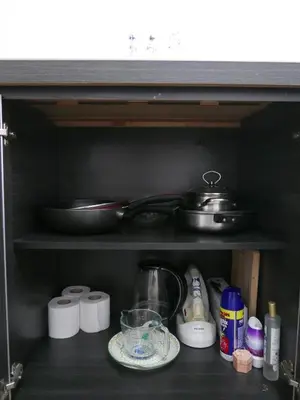 a kitchen shelf with a pot and pans on it at little heritage home in George Town