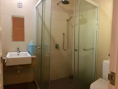 a bathroom with a shower and a sink at Island Hostel Bayan Lepas Airport in Bayan Lepas