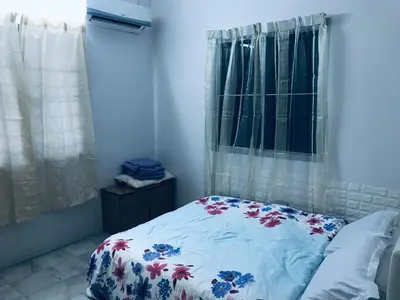 a bedroom with a bed with a floral bedspread at CoZy and comfortable Homestay in sungai siput in Sungai Siput