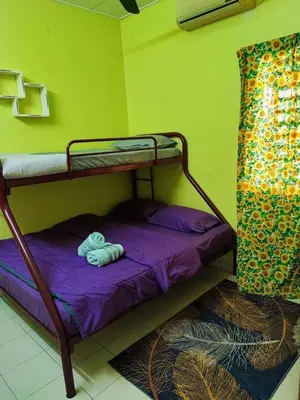 a bunk bed in a room with a purple mattress at Homestay D'Lily in Ipoh