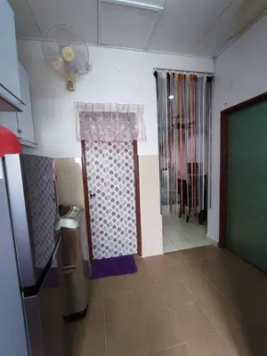 a room with a refrigerator and a door with a window at Homestay D'Lily in Ipoh