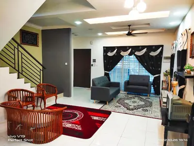 a living room with two chairs and a couch at Sweet40 Homestay in Kampong Batu Lapan