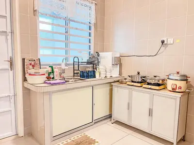 a kitchen with white cabinets and a sink at Golden Sweet Home @ CH Golden Hills (Night Market) in Cameron Highlands