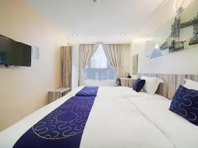 a hotel room with a large bed and a tv at Avatel Bukit Mertajam in Bukit Mertajam