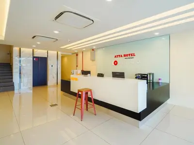 an office lobby with a counter and a stool at Avatel Bukit Mertajam in Bukit Mertajam