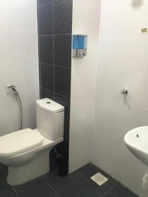 a bathroom with a toilet and a sink at Cozy Corner Homestay in Kepala Batas