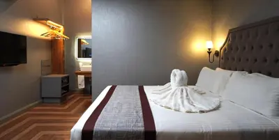 a hotel room with a bed with a dress on it at 1969 Business Suites @ Ipoh Garden in Ipoh