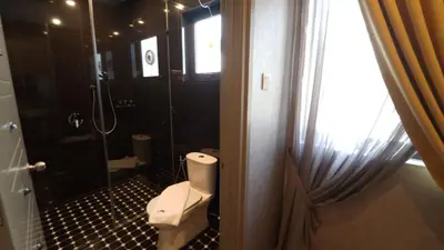 a bathroom with a toilet and a glass shower at 1969 Business Suites @ Ipoh Garden in Ipoh