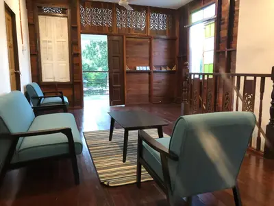 a living room with chairs and a table at Suri Homestay, Taiping in Taiping
