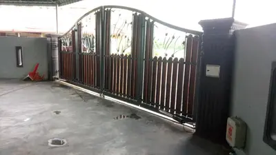 a metal gate in a room with a concrete floor at RIZQI HOMESTAY Sungai Siput with Wifi! Islamic Guest Only! in Kampong Rimba Panjang