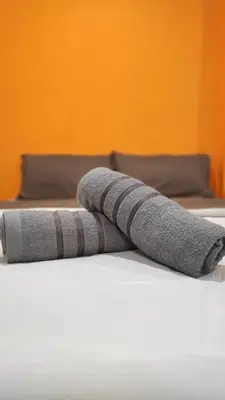 two towels sitting on top of a bed at YipStay in Gopeng