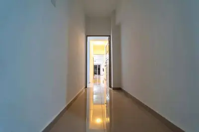 a hallway with white walls and a long hallway at Star Light Homestay 19@ The Venus in Sitiawan