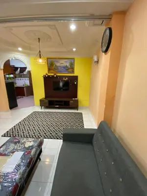 a living room with a couch and a tv at PJM HILL VIEW HOMESTAY in Ipoh