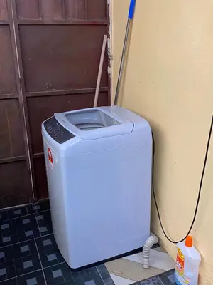 a washing machine sitting in front of a door at PJM HILL VIEW HOMESTAY in Ipoh